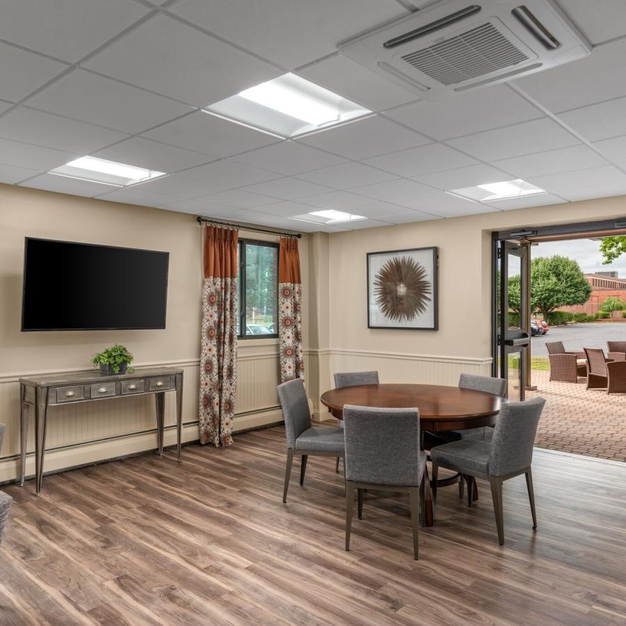 a room with a tv and chairs